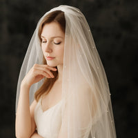 Woman wearing a veil with a dark background